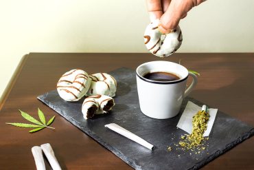 Person dipping in a cannabis infused donut in their coffee